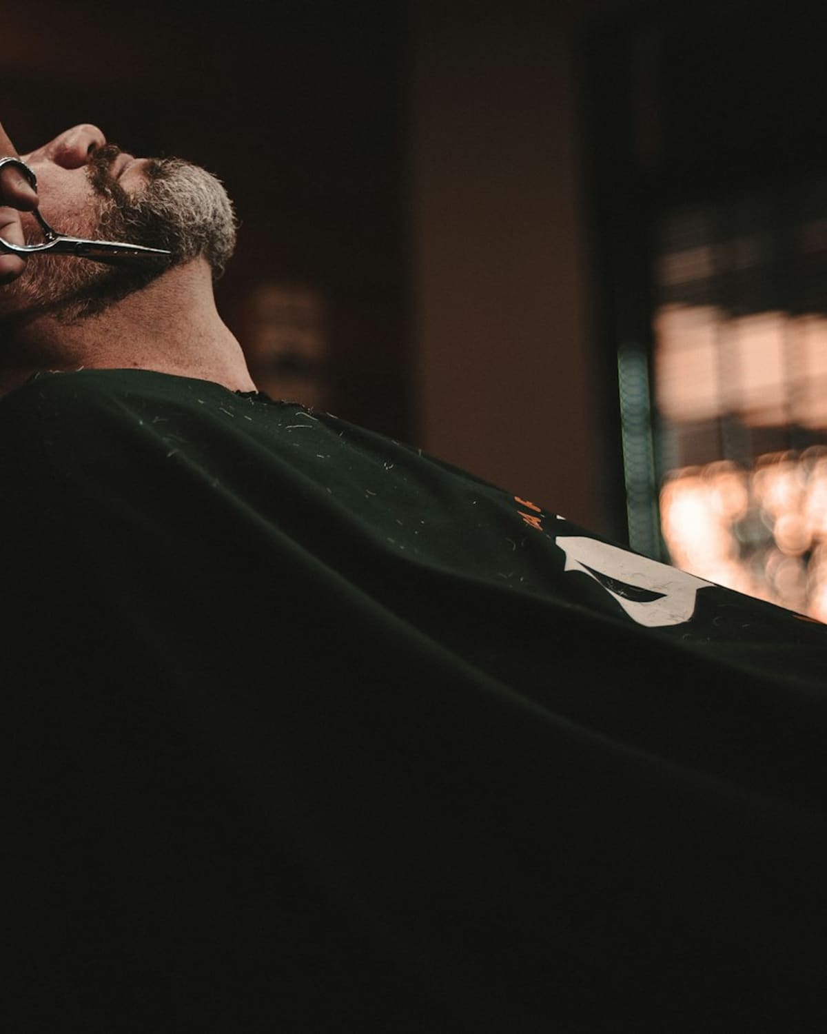 A barber at work in a warm shop
