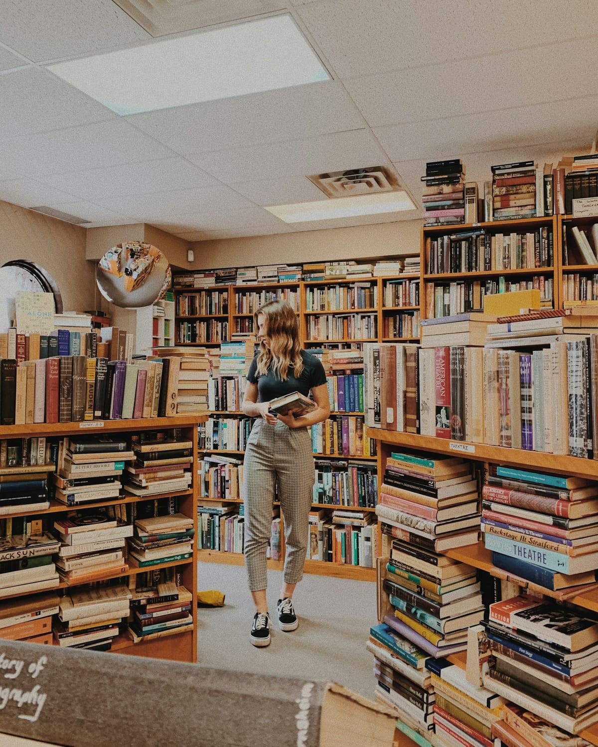 A bookseller among the stacks of a secondhand shop
