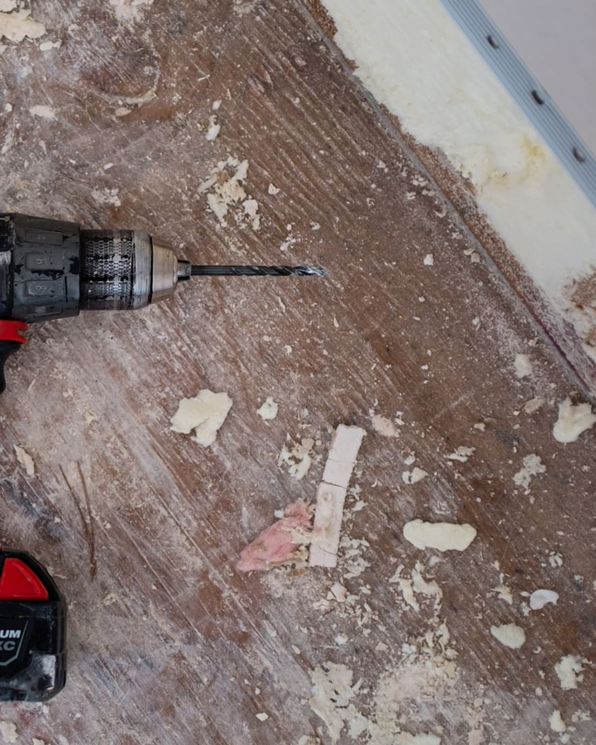 A carpenter planing a length of timber