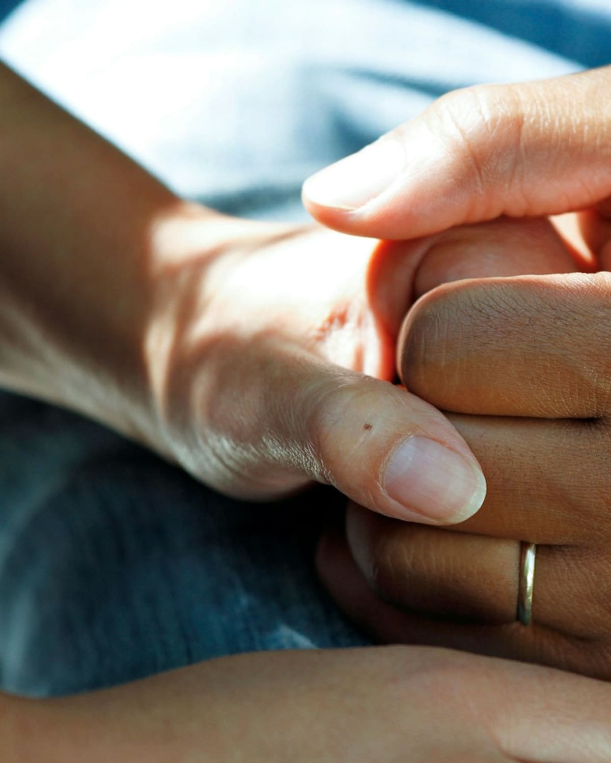 A midwife's hands cradling a newborn's foot
