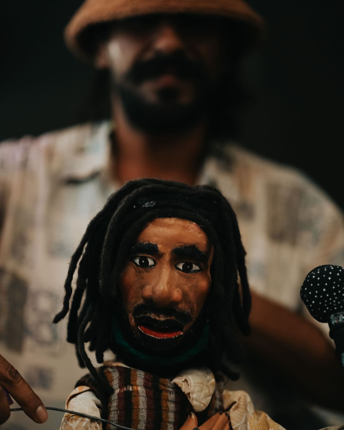 A puppeteer operating a hand-carved marionette during a performance