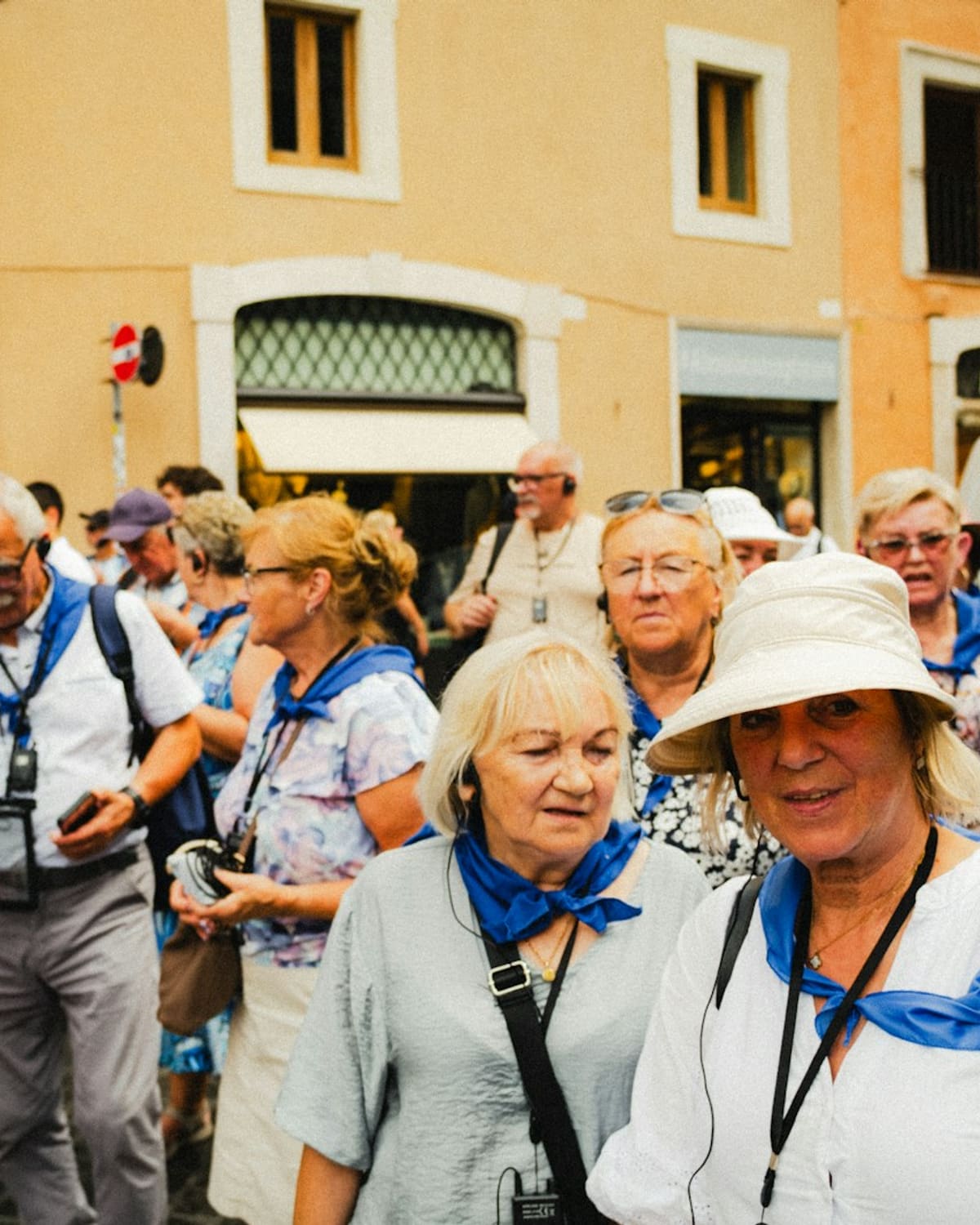 A guided group of travelers in a sunlit old-town street